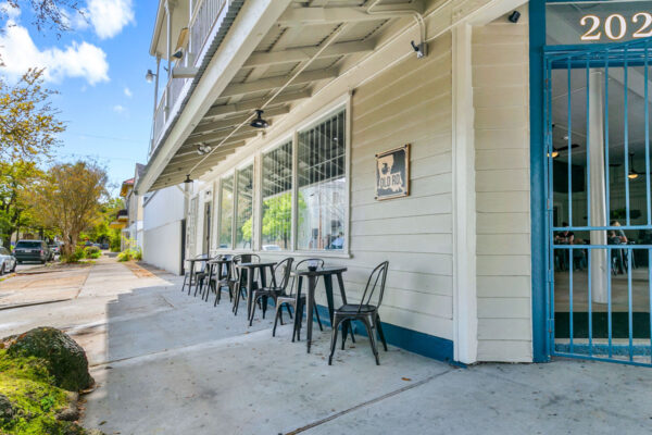 Outdoor seating shaded by a 300 year old live oak tree.